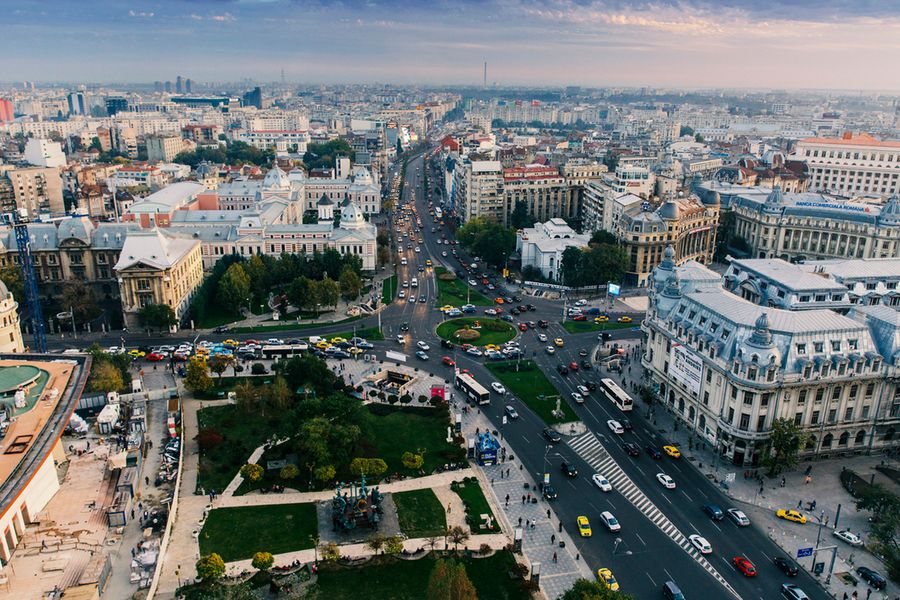 A photo taken outside of a café in Bucharest at dusk.
