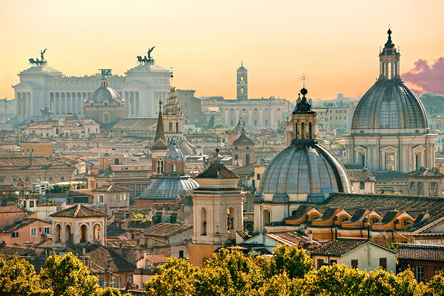 A photograph of rooftops in Rome at sunset.