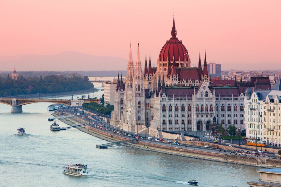 A photo of the Hungarian parliament building in Budapest by the river.